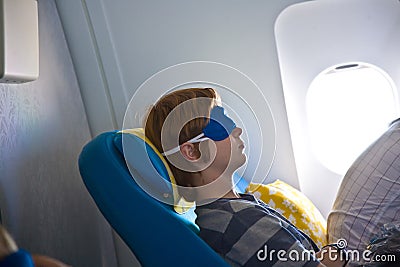 Young passenger sleeping in the aircraft Stock Photo