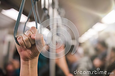 Young passenger woman hand holding Handle on the train or on the bus for safety. Safety travel trip Stock Photo