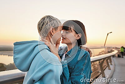 Young passionate lesbian couple going to kiss, Two women enjoying romantic moments together at sunrise Stock Photo