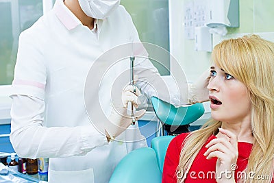 Young patient in dentist office, afraid of anesthetic injection, Stock Photo
