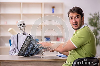Young male patient visiting skeleton doctor Stock Photo