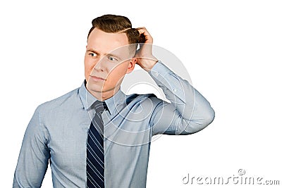 Young pensive businessman dressed in blue shirt and tie think, isolated on white background Stock Photo