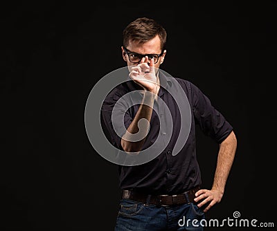 Young pensive man showing by hands Stock Photo
