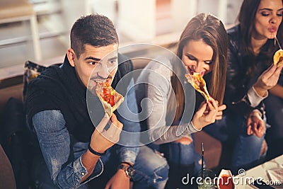 Young people in casual clothes eating pizza Stock Photo