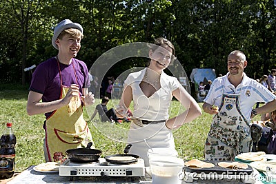 Young people cooking pancakes Editorial Stock Photo