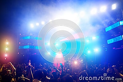 Young people dancing and having fun in summer festival party outdoor - Crowd with hands up and smarphones celebrating fest concert Editorial Stock Photo