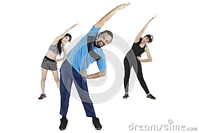 Young people doing stretching together Stock Photo