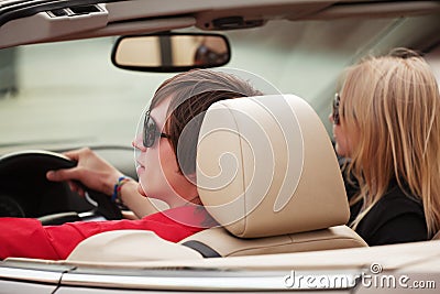 Happy young couple driving convertible car Stock Photo