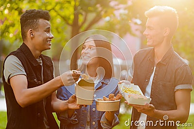 Young people eating and talking Stock Photo