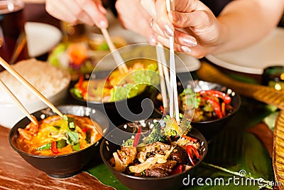 Young people eating in Thai restaurant Stock Photo