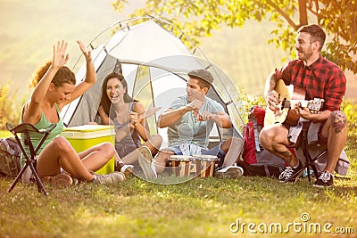 Young people enjoy in music of drums and guitar on camping trip Stock Photo