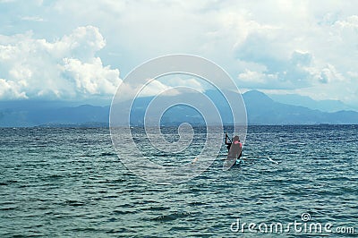 Young people enjoy riding on tiny small boat on sea Editorial Stock Photo
