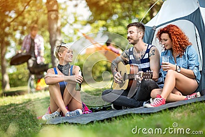 Young people enjoys on excursion with beer and guitar Stock Photo