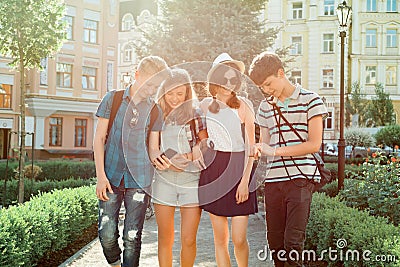 Young people friends walking in the city, a group of teenagers talking smiling having fun in the city. Friendship and people Stock Photo