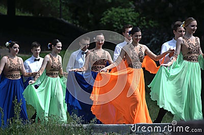 Young people going to a stage to dance waltz. Costume ball of high-school graduates Editorial Stock Photo