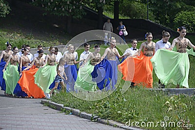 Young people going to a stage to dance waltz. Costume ball of high-school graduates Editorial Stock Photo