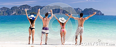 Young People Group On Beach Summer Vacation, Two Couple Raised Hands Friends Seaside Stock Photo