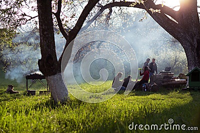 Young people having barbecue out in the garden Editorial Stock Photo