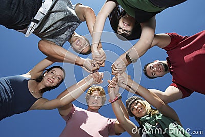 Young People Holding Hands In Circle Stock Photo