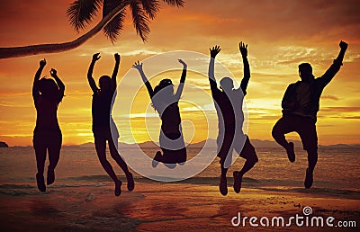 Young People Jumping with Excitement on the Beach Stock Photo