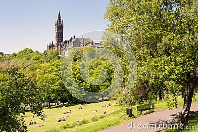 Young people on the lawns of Kelvingrove park, the University in the background Editorial Stock Photo