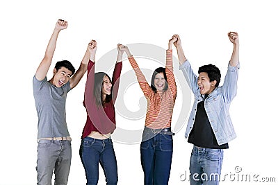 Young people lifting hands together on studio Stock Photo