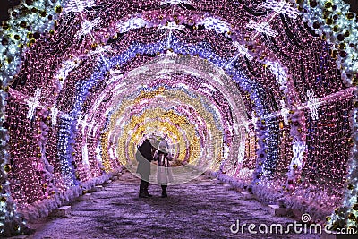 Young people in lit with colored lights the tunnel to Pushkinskaya square, Moscow Editorial Stock Photo