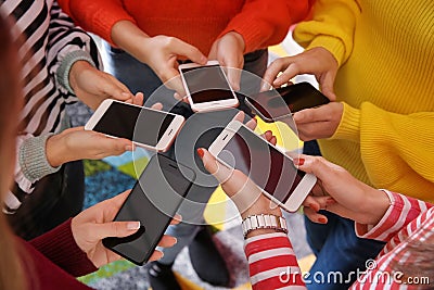 Young people with mobile phones standing in circle. Concept of addiction Stock Photo