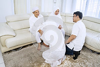 Young people and old parents forgiving each other Stock Photo