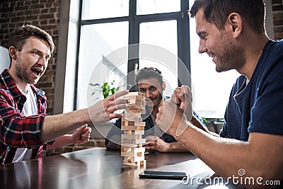 Young people playing jenga game Stock Photo