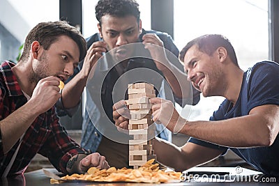 Young people playing jenga game Stock Photo