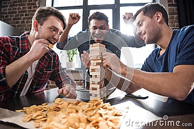 Young people playing jenga game Stock Photo