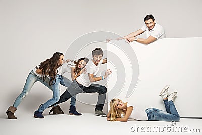 Young people pushing white board Stock Photo