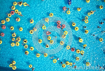 Young people relax in swimming pool at bubble bath. Stock Photo