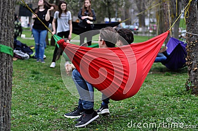 Young people relaxing in hammocks in the park Editorial Stock Photo