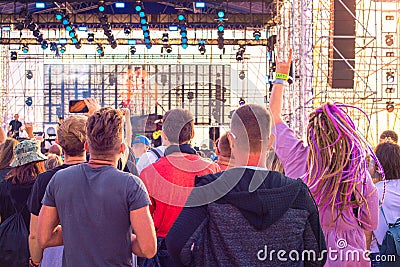 Young people at a street music festival raised their hands up and dance Editorial Stock Photo