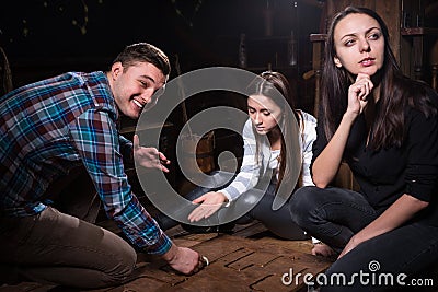 Young people thinking and moving parts of a conundrum to get out Stock Photo