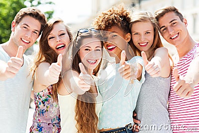 Young people with thumbs up Stock Photo