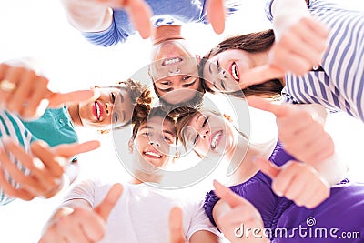 Young people with thumbs up Stock Photo