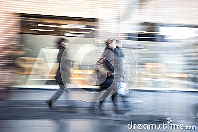 Young people walking in shopping centre, zoom effect, motion blur Stock Photo