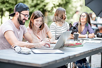 Young people working at the outdoor cafe Stock Photo