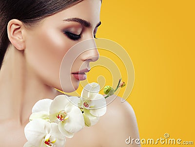 Young Perfect Woman Face with Makeup and Orchid Flowers Stock Photo