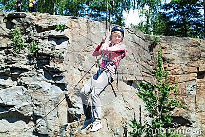 Young perfect woman sliding on a zip line Stock Photo