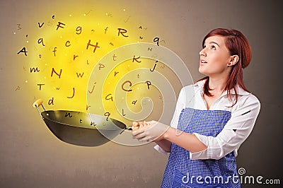 Person cooking letters in wok Stock Photo