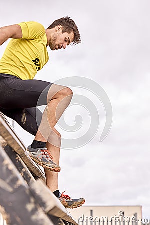 Young person going through an obstacle course in a Spartan race Stock Photo