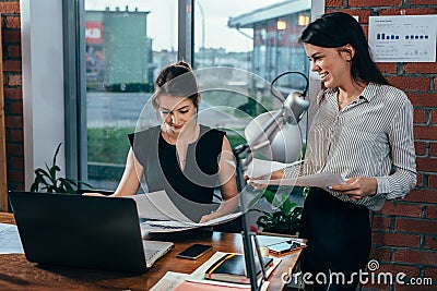 Young personal assistant discussing plans with boss in her office Stock Photo