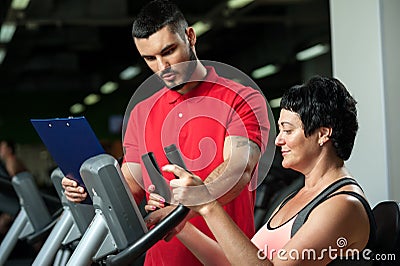 Brunette woman working out with personal coach Stock Photo