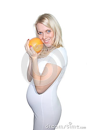 Young Petty Natual Beauty Pregnant Woman Holding Grapefruit and Shows a Belly That Begins to Grow Isolated on White Background. Stock Photo