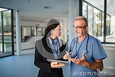 Young pharmaceutic seller explaining something to doctor in hospital. Stock Photo