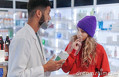 Young pharmacist helping customer to choos medication. Stock Photo